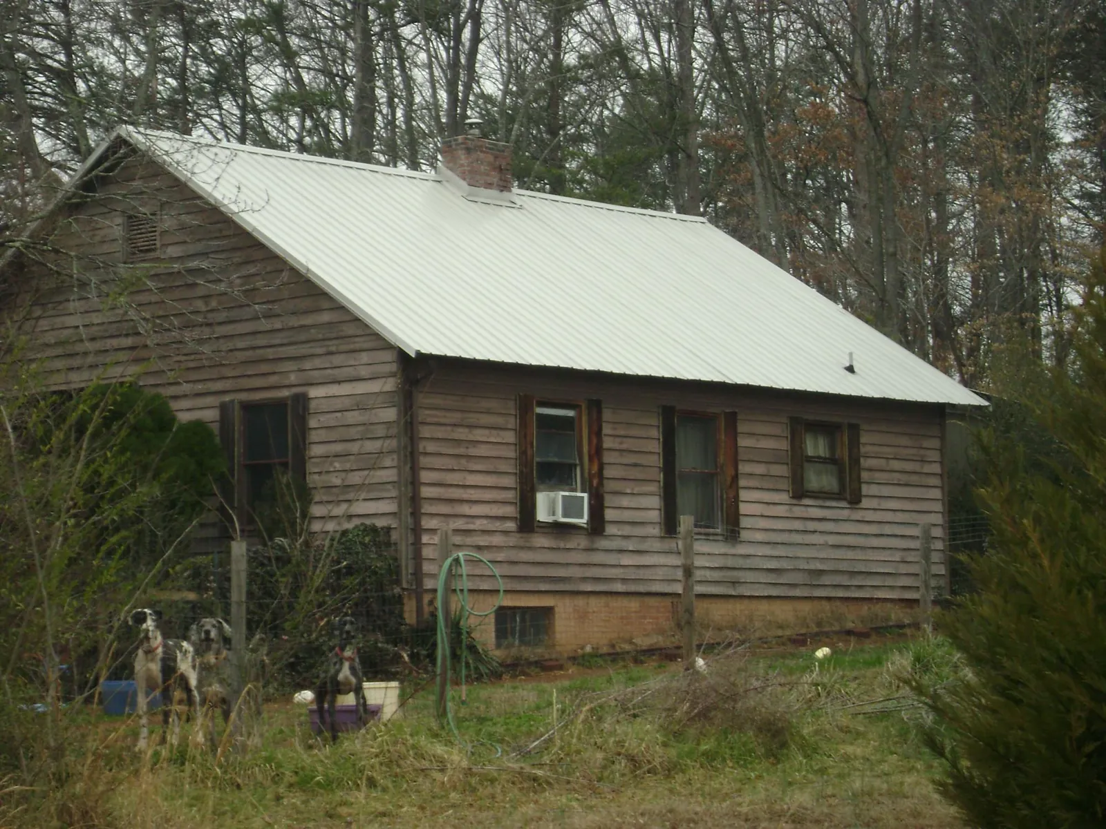 White metal roof on an old wood sided farmhouse, from a Metal Roof Installation job in Ulmer